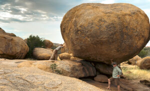 Viajeros en un paisaje rocoso durante una ruta de safari en África.
